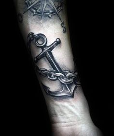 a black and white anchor tattoo on the arm