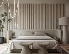 a modern bedroom with two stools in front of the bed