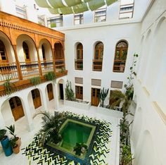 an indoor courtyard with potted plants and tiled floor