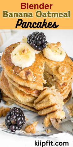 a stack of pancakes topped with bananas and blackberries