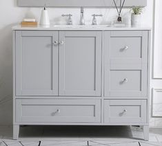 a bathroom vanity with two sinks and mirrors