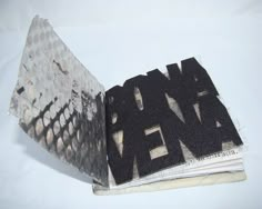 an open book with black and white designs on it