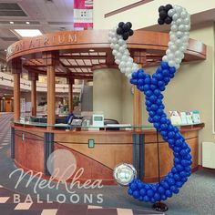 balloons are arranged in the shape of an anchor on display at a mall lobby entrance