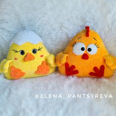 two stuffed animals sitting next to each other on a white surface, one with an angry face