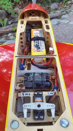 the inside of a kayak with many wires and batteries