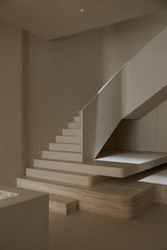 an empty room with white stairs and no people in the area or furniture on the floor