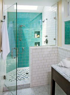 a bathroom with a walk in shower next to a white sink and tiled flooring