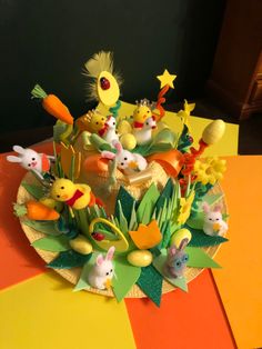 a cake decorated with many different types of animals and plants on top of a table