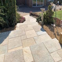 a stone walkway in front of a brick building