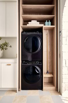 a washer and dryer sitting in a cabinet next to each other on the floor