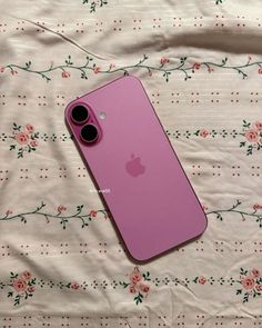 an iphone 11 is laying on a bed