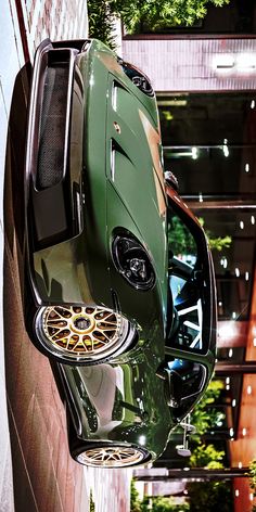 an overhead view of a green car parked in front of a building