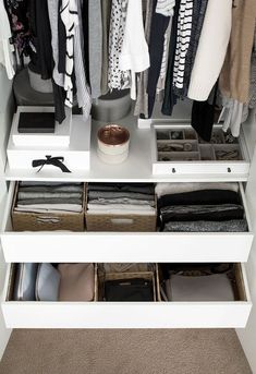 an organized closet with drawers and clothes