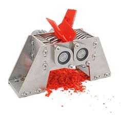 a machine that has some kind of red food in it's mouth and is on the ground