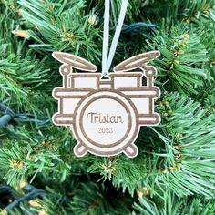 a wooden ornament hanging from a christmas tree with the name trisiann on it