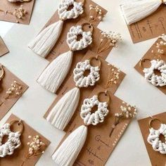 some tassels are laying on top of brown tags and hang from them with white beads