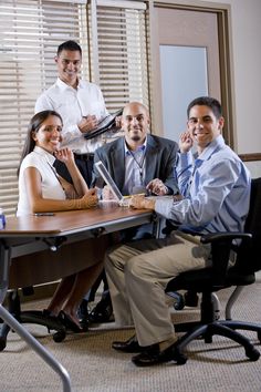 a group of business people sitting around a table