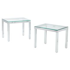 two clear glass tables sitting next to each other