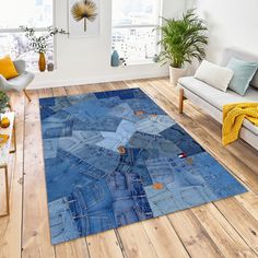 a living room with a couch, chair and rug made out of blue jean fabric