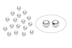 a bunch of balls sitting on top of a white table next to a circle with holes in it