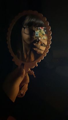 a woman taking a selfie in front of a mirror