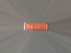 an orange and silver plate with the word gates on it