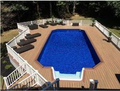 an above ground swimming pool surrounded by decking