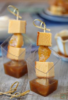 two small desserts are sitting in cups on a table