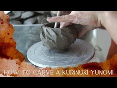 a person is making something out of clay with their hand and thumb on the wheel