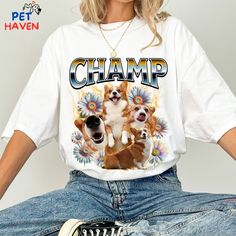 a woman wearing a white shirt with two dogs on it and the words champ printed on it