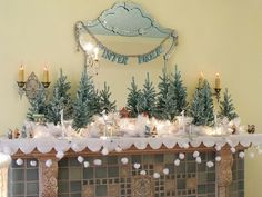 a mantel decorated with christmas trees and candles