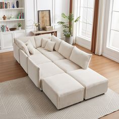 a living room with a large white sectional couch