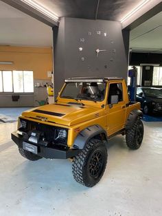 a yellow truck is parked in a garage