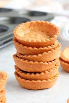 a stack of mini pies sitting on top of a counter