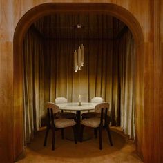 a dining room table with two chairs and a chandelier hanging from the ceiling