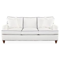 a white couch with black trim and pillows on it's back end, against a white background