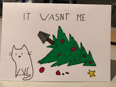 a handmade christmas card with an image of a cat and a tree on it