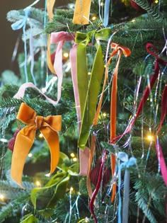 a christmas tree decorated with ribbons and lights