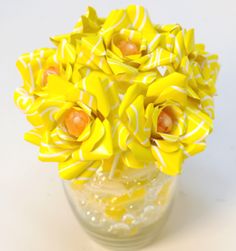 a vase filled with yellow flowers on top of a table