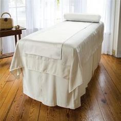 a bed with a white cover on top of it