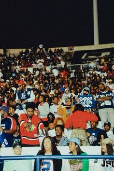 a group of people sitting in the stands at a football game