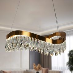 a chandelier hanging from the ceiling in a living room