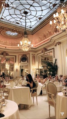 people sitting at tables in a fancy restaurant