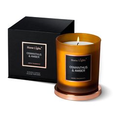 an orange candle sitting next to a black box