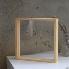 a wooden frame with pressed flowers in it