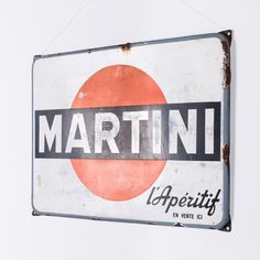 a sign hanging from the side of a building that says martini'an aperittif