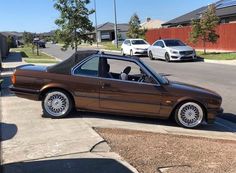 a brown car parked on the side of a street