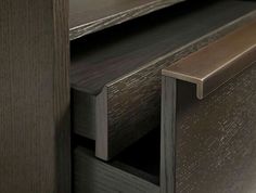 a close up of a wooden cabinet with metal handles and wood grained finish on the doors