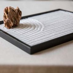 a rock sitting on top of a white mat