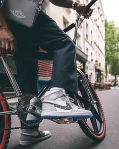 a close up of a person riding a bike with shoes on the front and side